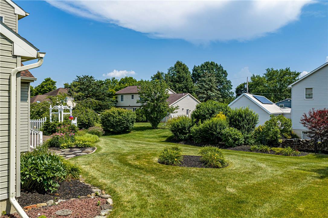 4568 Greenfield Road Bethlehem, PA 18017 - Photo 40 of 59 A well-maintained lawn and verdant landscaping define this charming backyard oasis.