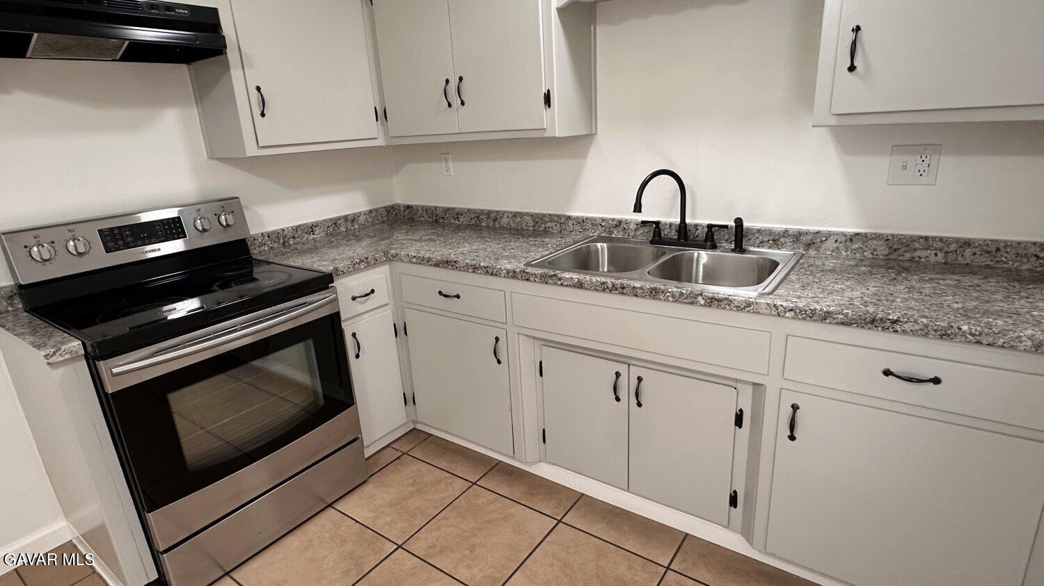 3901 Soranno Avenue, Unit C Bakersfield, CA 93309 - Photo 3 of 11 a kitchen with granite countertop white cabinets stainless steel appliances and sink