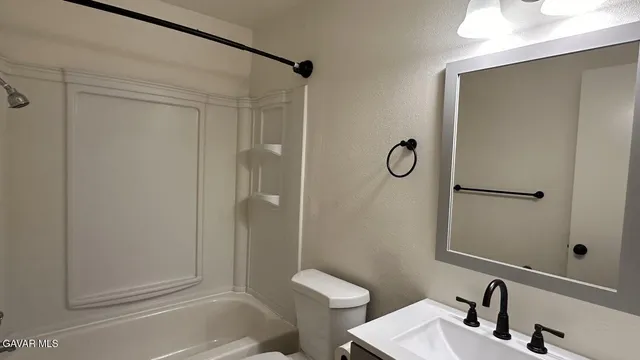 a bathroom with a shower and a sink