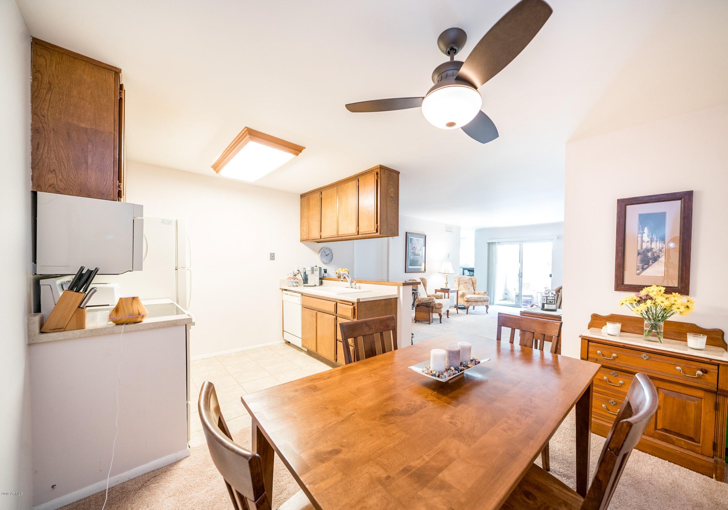 5525 East Thomas Road, Unit B6 Phoenix, AZ 85018 - Photo 1 of 21 a view of a dining room with furniture and a chandelier