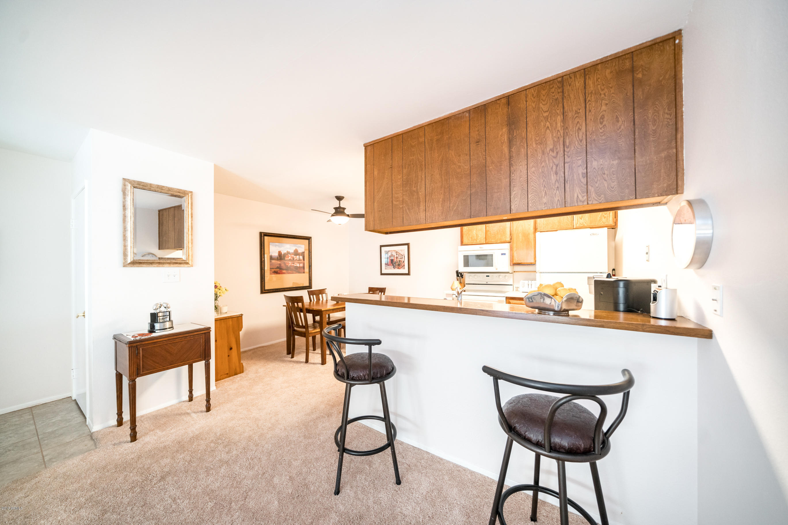 5525 East Thomas Road, Unit B6 Phoenix, AZ 85018 - Photo 13 of 21 a kitchen with a table chairs and a bed
