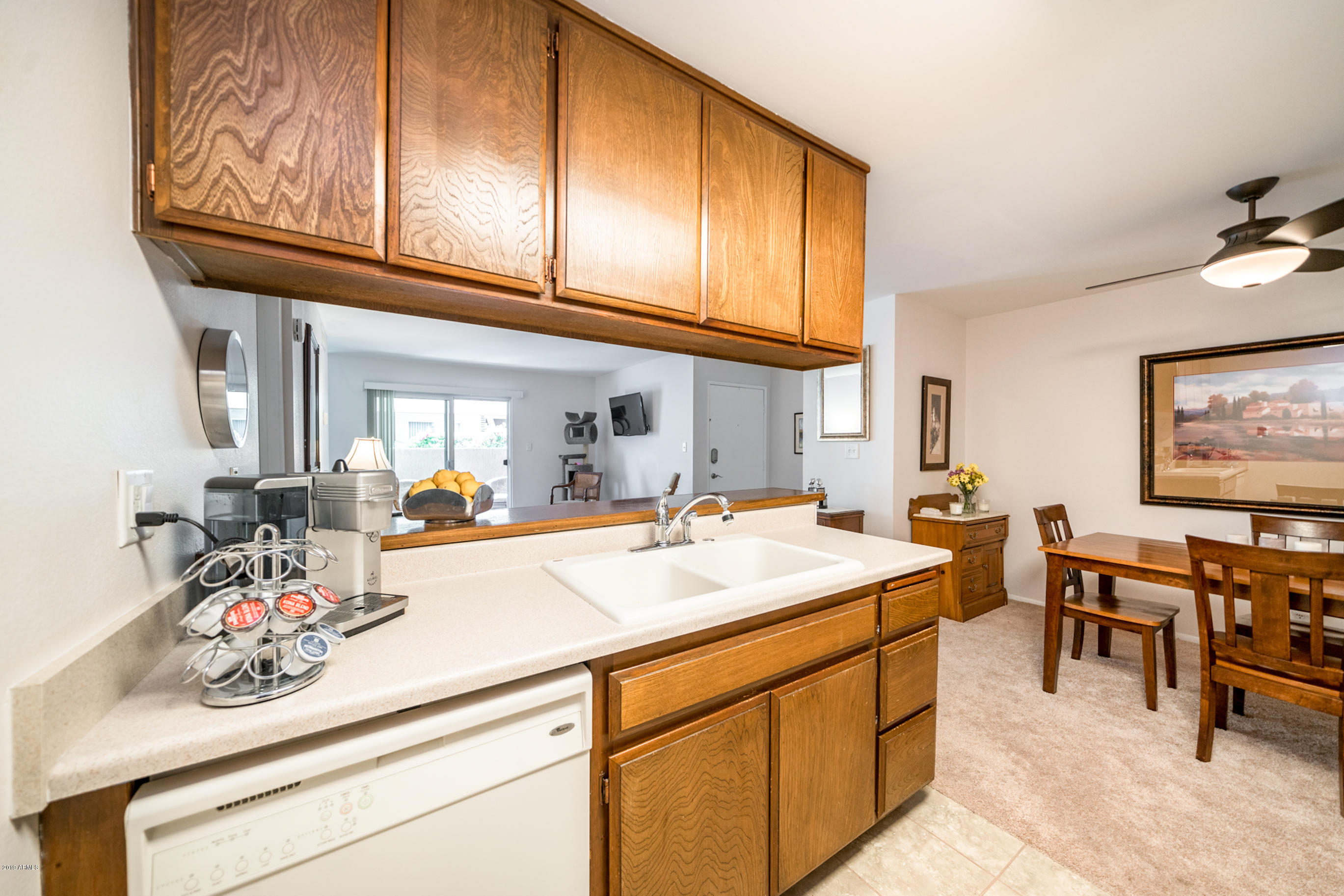 5525 East Thomas Road, Unit B6 Phoenix, AZ 85018 - Photo 14 of 21 a room with stainless steel appliances kitchen island granite countertop a sink and cabinets