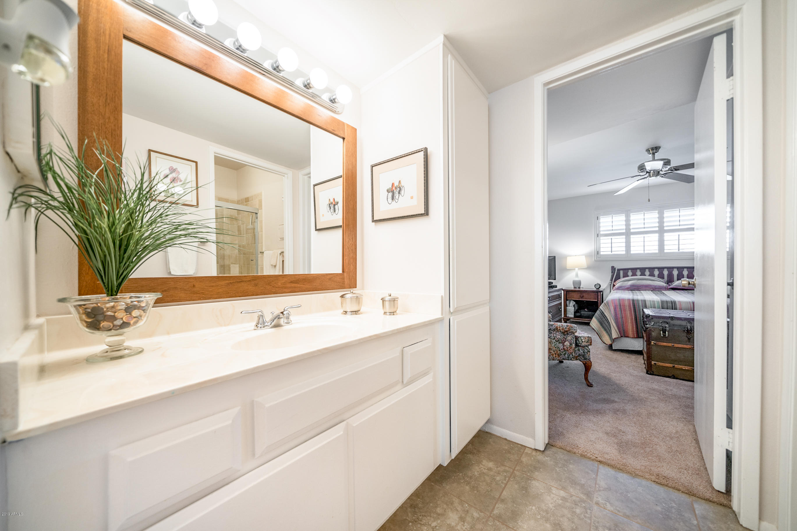 5525 East Thomas Road, Unit B6 Phoenix, AZ 85018 - Photo 5 of 21 a en suite bathroom with a sink a mirror and a shower