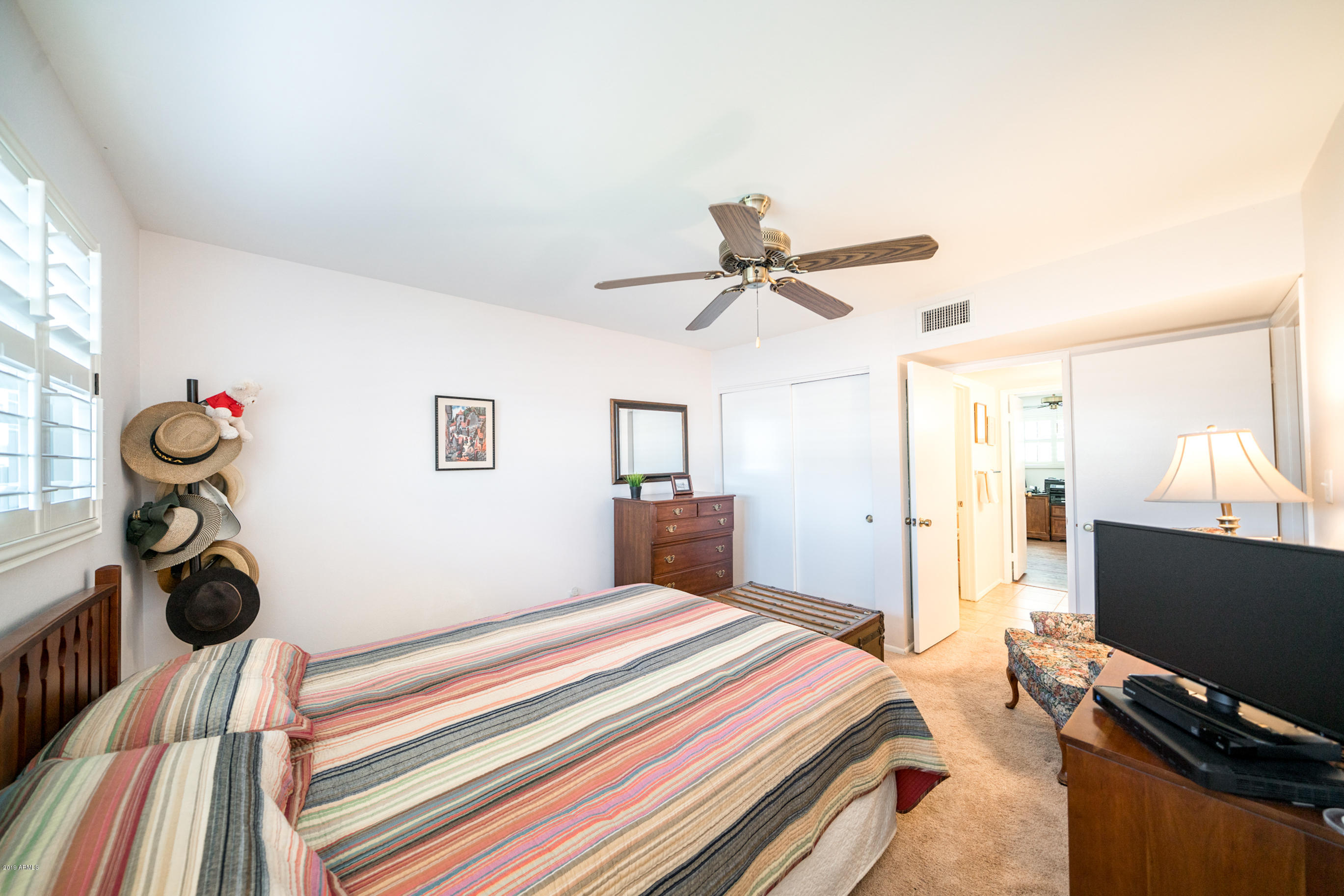 5525 East Thomas Road, Unit B6 Phoenix, AZ 85018 - Photo 8 of 21 a bedroom with a bed and a flat screen tv