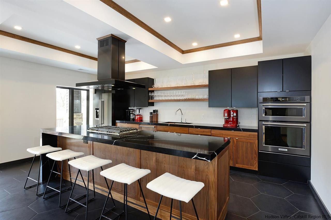 7717 Main Street Hunter, NY 12442 - Photo 13 of 32 a kitchen with stainless steel appliances granite countertop a stove a sink and a refrigerator