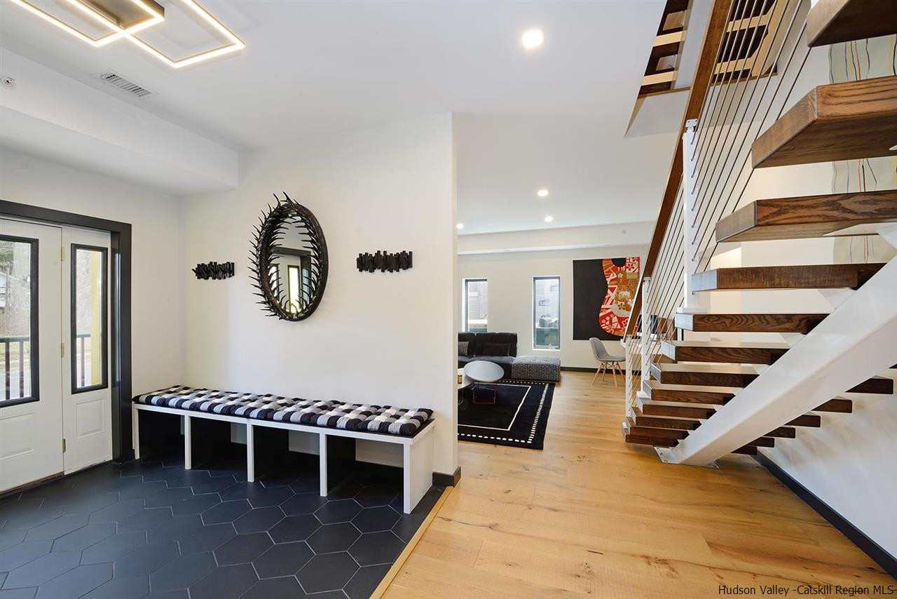 7717 Main Street Hunter, NY 12442 - Photo 17 of 32 a living room with furniture a rug and a window