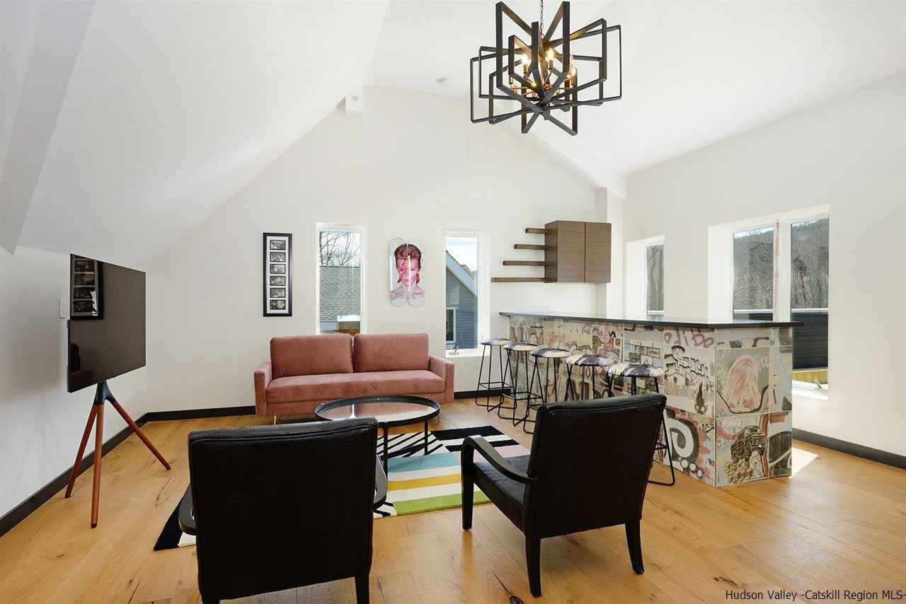 7717 Main Street Hunter, NY 12442 - Photo 21 of 32 a living room with furniture and a flat screen tv