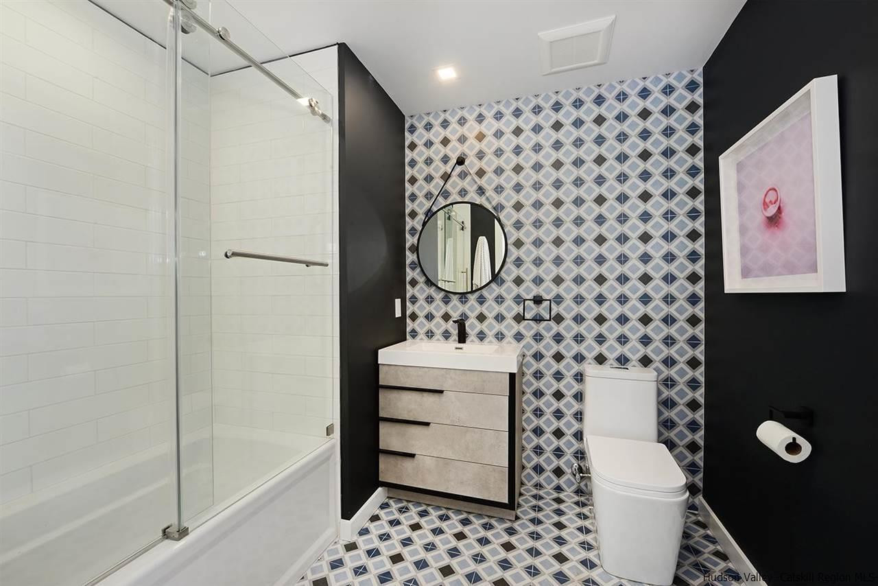 7717 Main Street Hunter, NY 12442 - Photo 24 of 32 a bathroom with a sink a toilet and shower