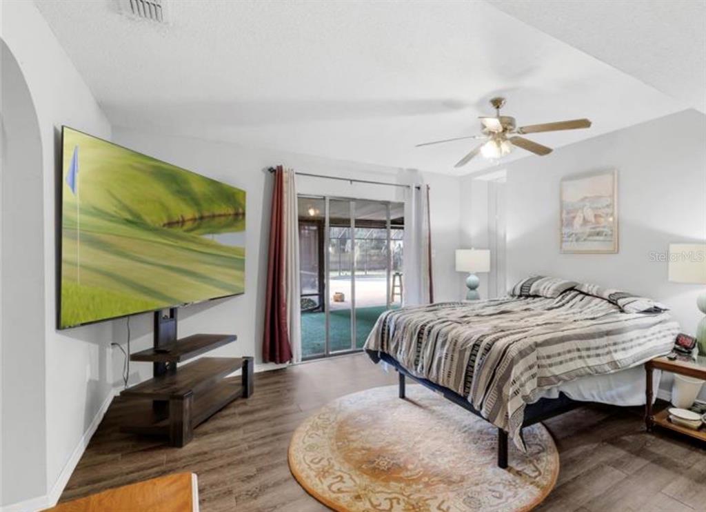 4308 Allen Road Fruitland Park, FL 34731 - Photo 21 of 33 a bedroom with a bed and a table
