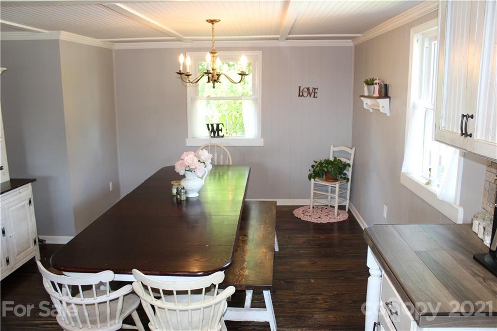 1528 Sandy Plains Road Tryon, NC 28782 - Photo 14 of 31 a table chair sitting in a room next to a window