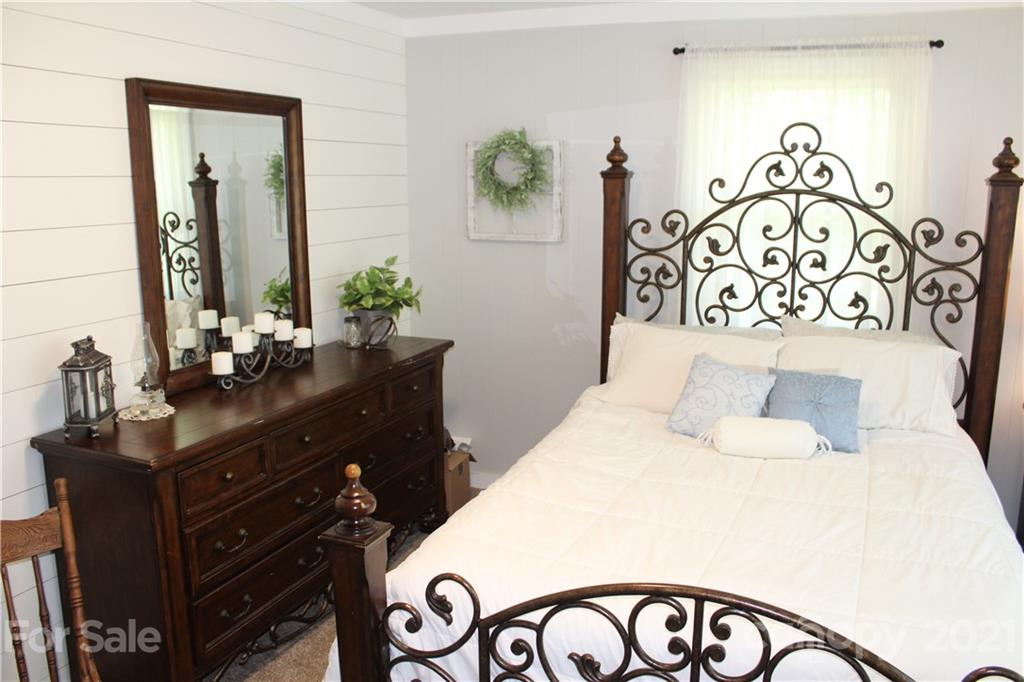 1528 Sandy Plains Road Tryon, NC 28782 - Photo 22 of 31 a bedroom with a bed and a table in it