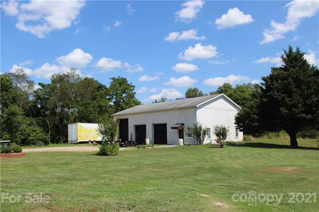 1528 Sandy Plains Road Tryon, NC 28782 - Photo 4 of 31 a view of a white house with a big yard and large trees