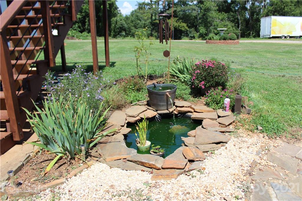 1528 Sandy Plains Road Tryon, NC 28782 - Photo 8 of 31 a view of a chair and table in the garden with wooden fence