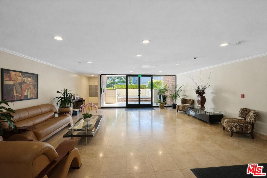 5100 Vía Dolce, Unit 305 Marina del Rey, CA 90292 - Photo 11 of 54 a living room with furniture and a large window