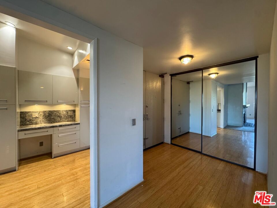 5100 Vía Dolce, Unit 305 Marina del Rey, CA 90292 - Photo 24 of 54 a view of a hallway with an empty room and wooden floor