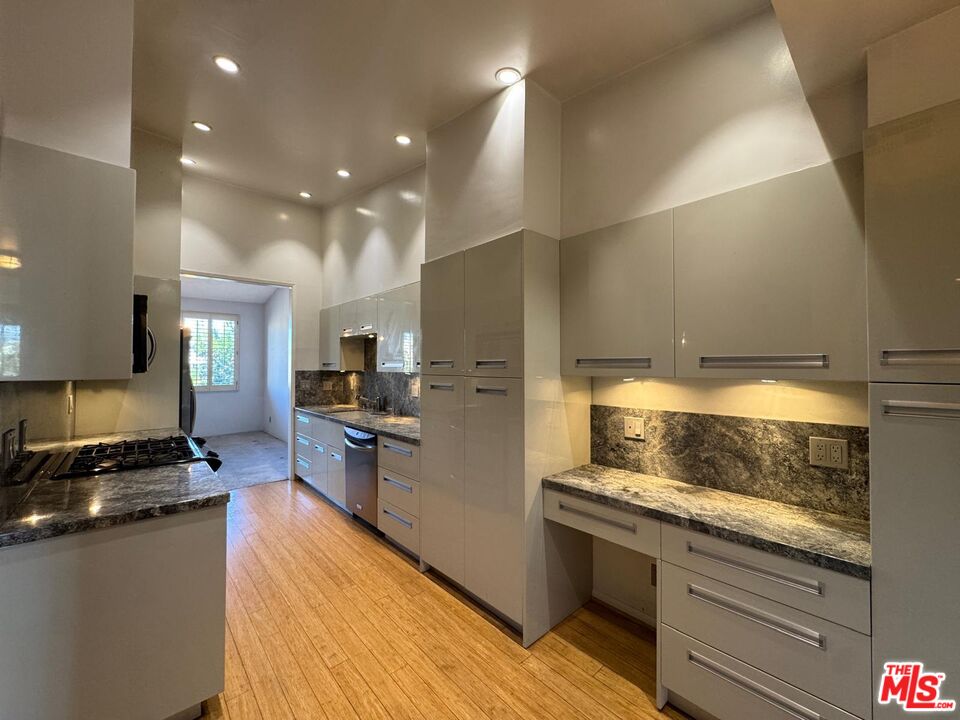 5100 Vía Dolce, Unit 305 Marina del Rey, CA 90292 - Photo 26 of 54 a kitchen with stainless steel appliances granite countertop a stove a sink and a refrigerator