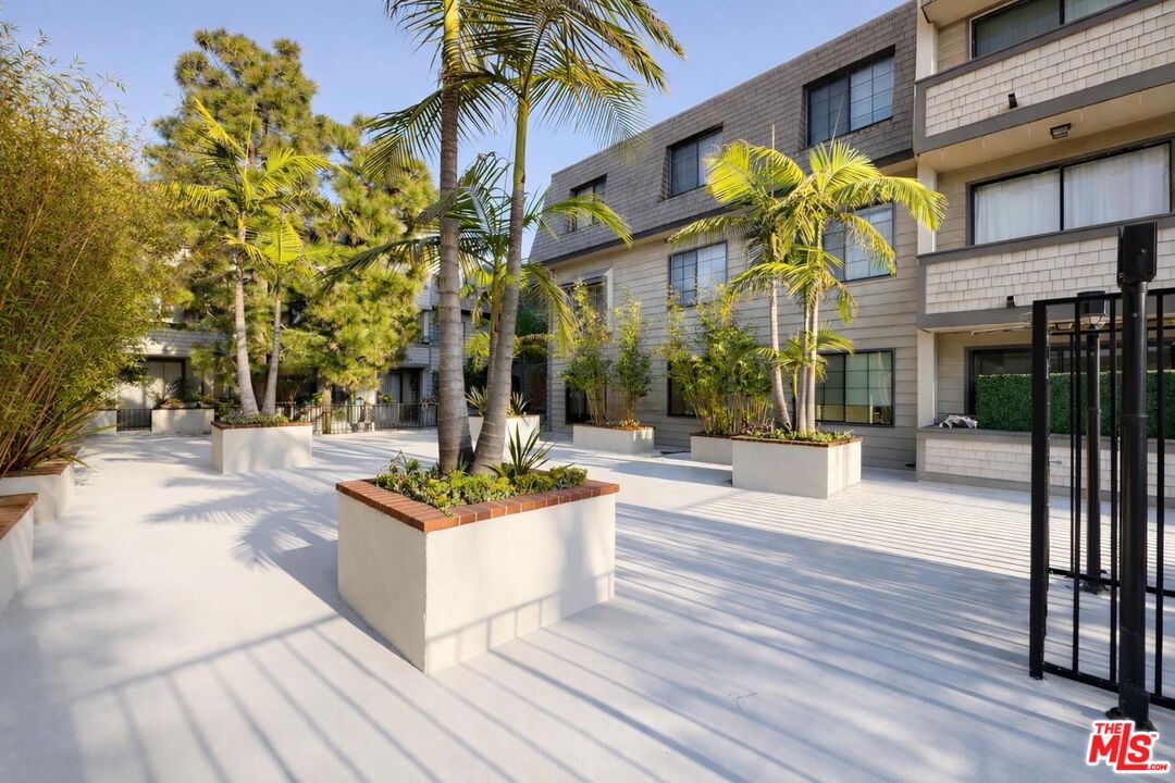 5100 Vía Dolce, Unit 305 Marina del Rey, CA 90292 - Photo 3 of 54 a view of a building with garden