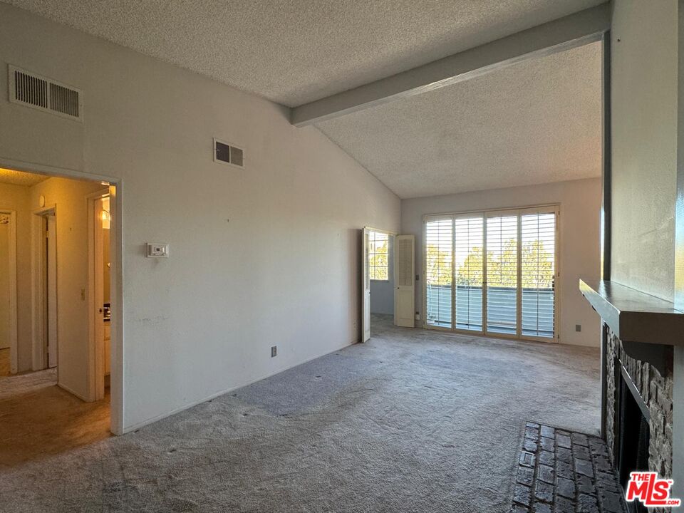 5100 Vía Dolce, Unit 305 Marina del Rey, CA 90292 - Photo 31 of 54 a view of an empty room with a fireplace