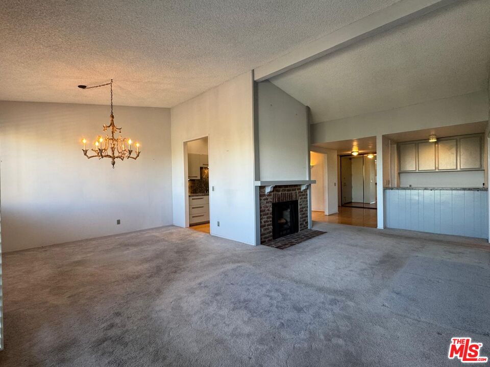 5100 Vía Dolce, Unit 305 Marina del Rey, CA 90292 - Photo 33 of 54 an empty room with chandelier and windows