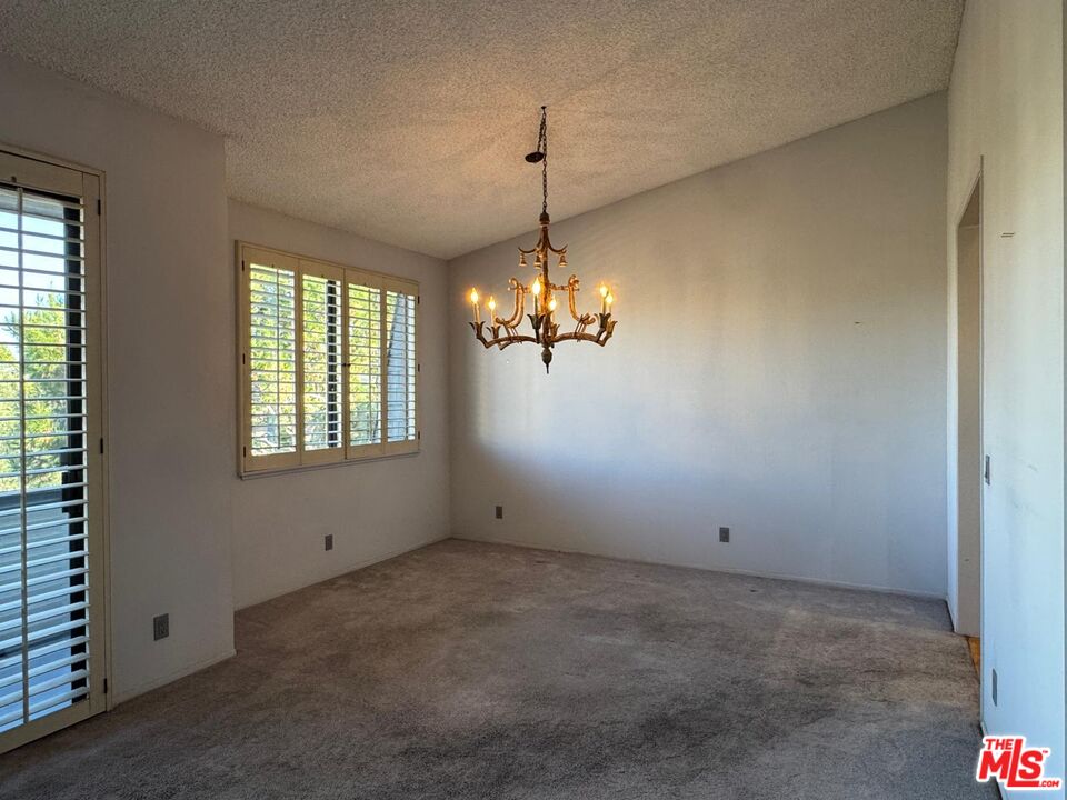 5100 Vía Dolce, Unit 305 Marina del Rey, CA 90292 - Photo 34 of 54 a view of a room with windows and chandelier