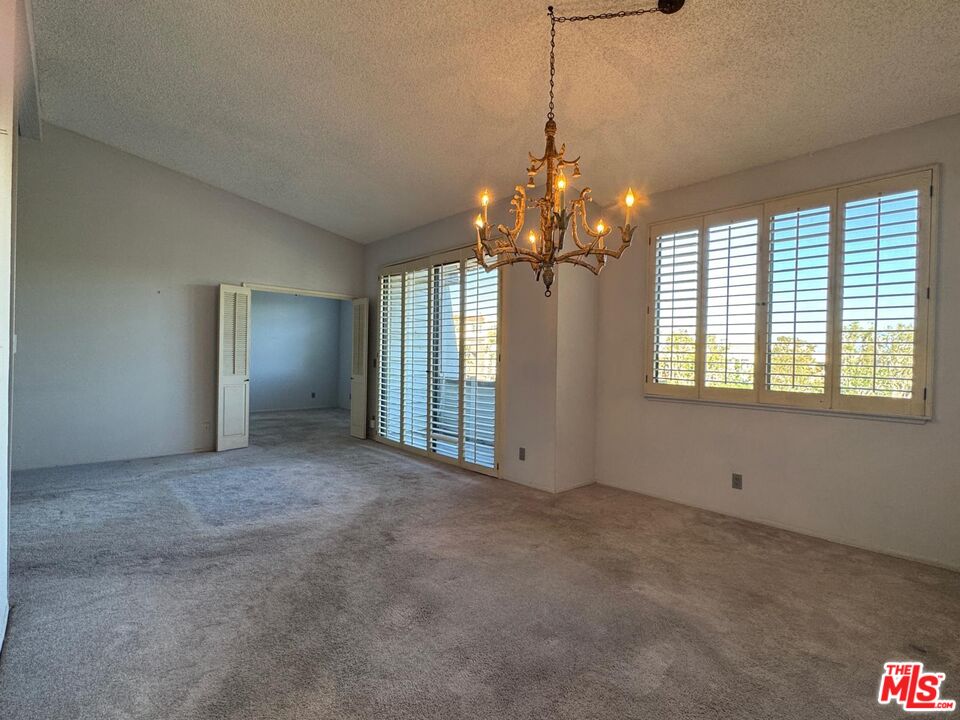 5100 Vía Dolce, Unit 305 Marina del Rey, CA 90292 - Photo 35 of 54 a view of a livingroom with a chandelier fan and windows