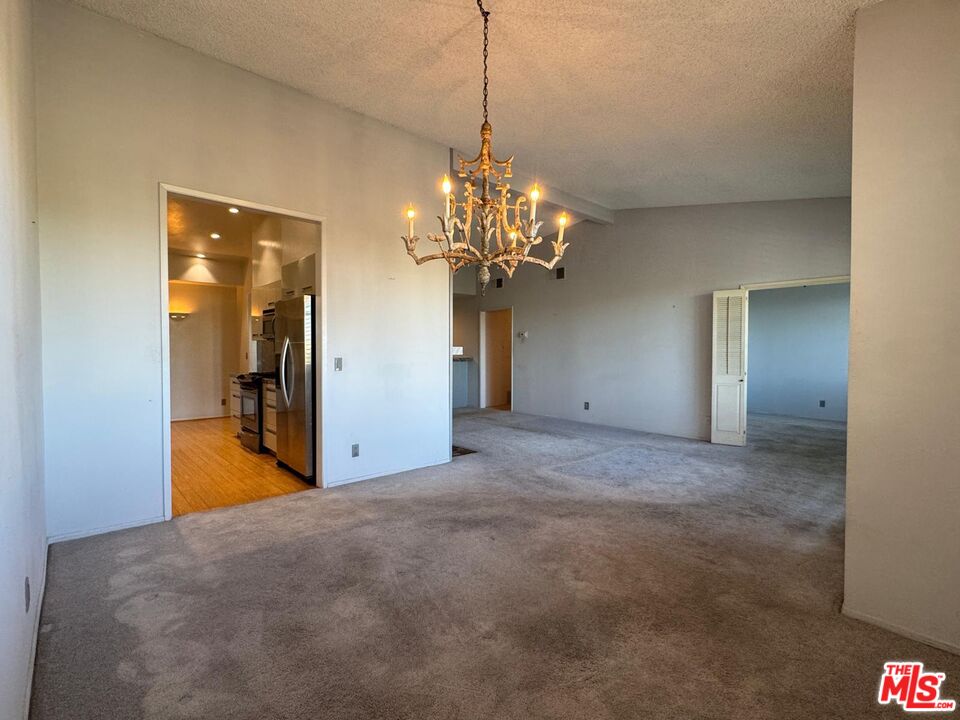 5100 Vía Dolce, Unit 305 Marina del Rey, CA 90292 - Photo 36 of 54 a view of a room with a chandelier and living room