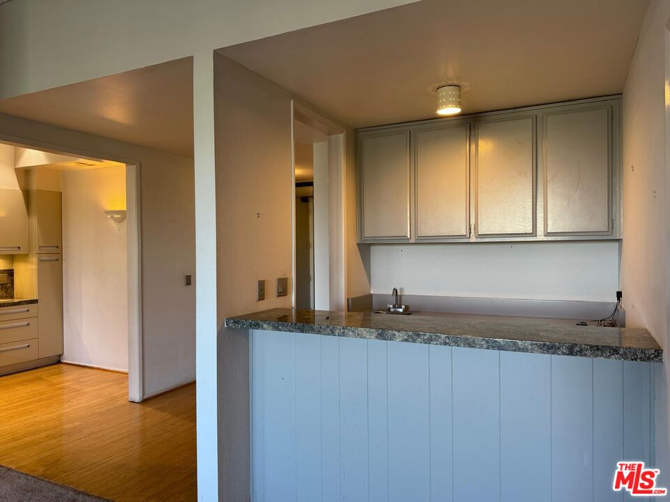 5100 Vía Dolce, Unit 305 Marina del Rey, CA 90292 - Photo 40 of 54 a kitchen with granite countertop a sink and cabinets