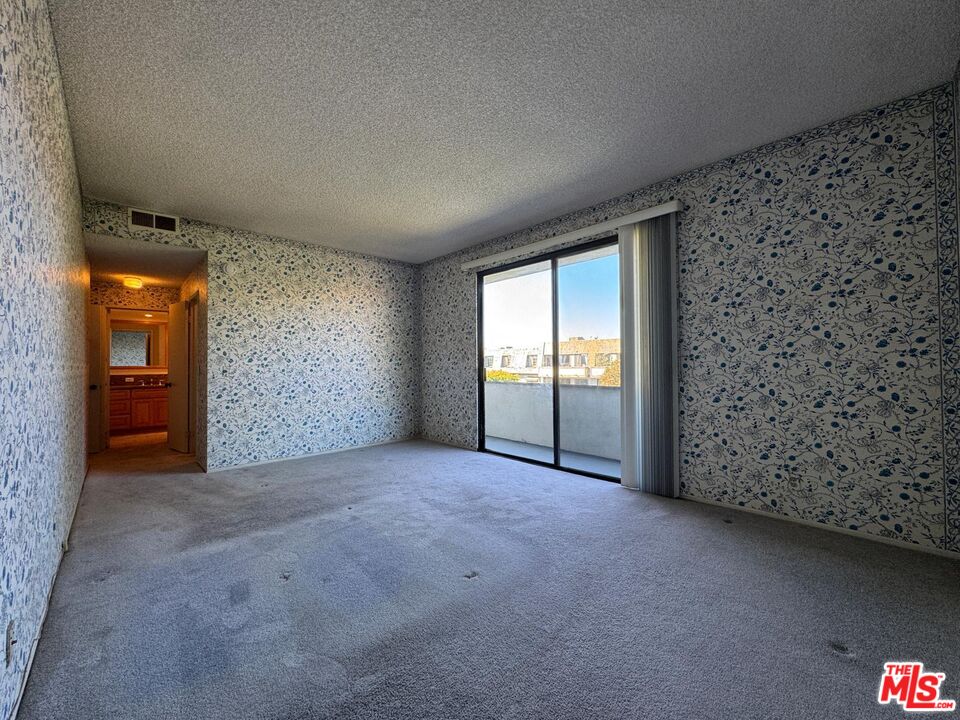 5100 Vía Dolce, Unit 305 Marina del Rey, CA 90292 - Photo 43 of 54 a view of an empty room with a fireplace