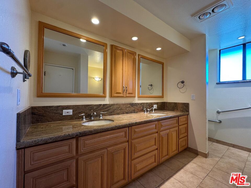 5100 Vía Dolce, Unit 305 Marina del Rey, CA 90292 - Photo 44 of 54 a bathroom with double sink and a mirror