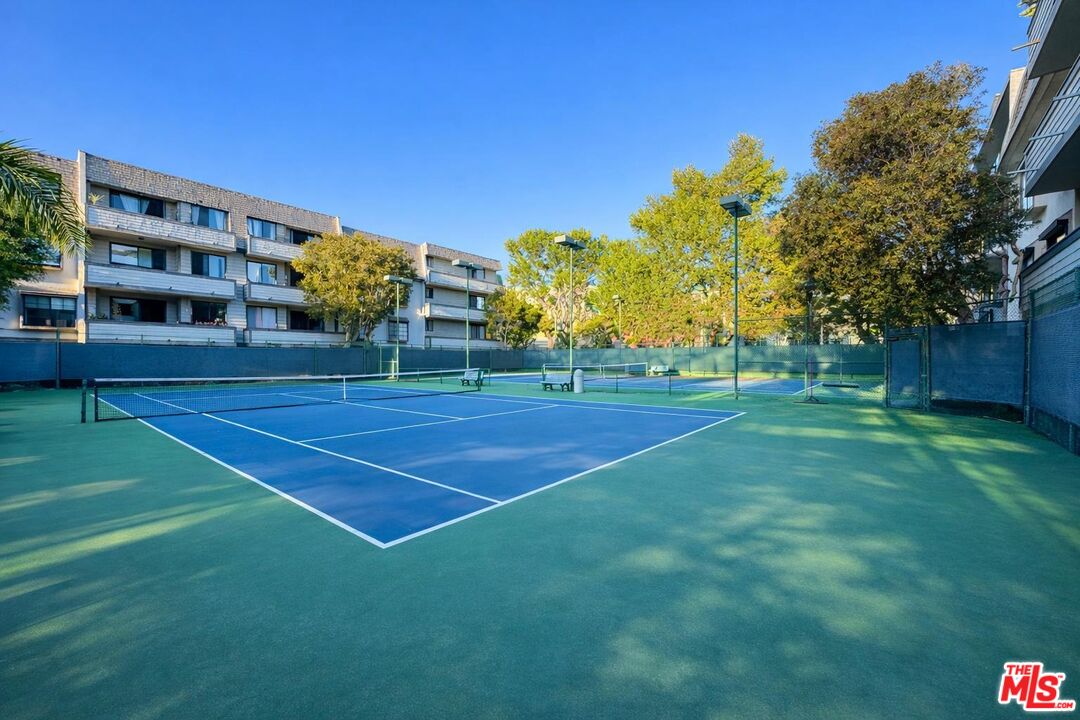 5100 Vía Dolce, Unit 305 Marina del Rey, CA 90292 - Photo 6 of 54 a view of a tennis ground with large trees