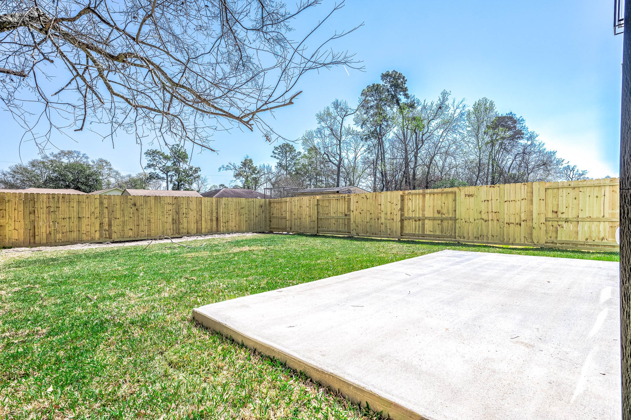 8602 Hoffman Street Houston, TX 77016 - Photo 27 of 30 Spacious backyard featuring a concrete patio slab, brand-new fence, and plenty of space for outdoor living.