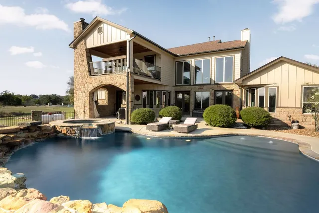a view of a swimming pool with a patio
