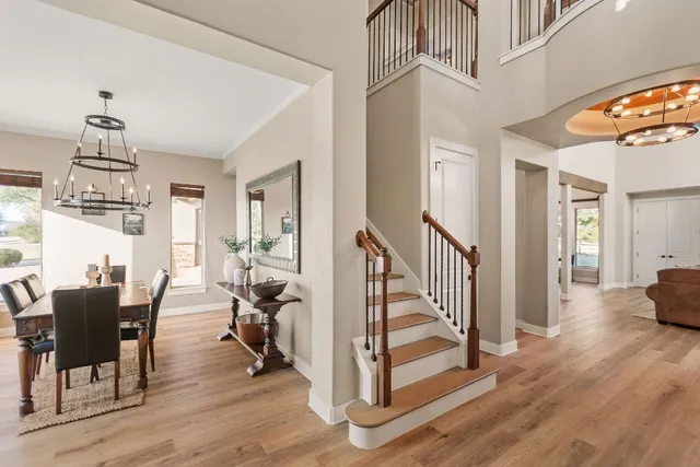 a kitchen island with stainless steel appliances granite countertop wooden floor and large window