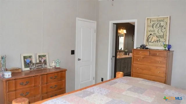 a bedroom with a bed and a dresser