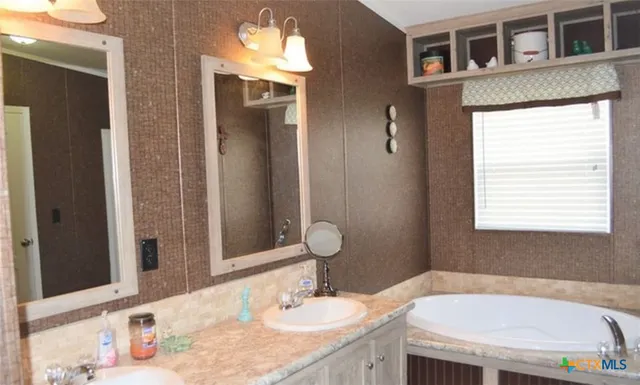 a bathroom with a sink and a mirror