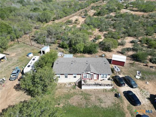 an aerial view of a house with yard