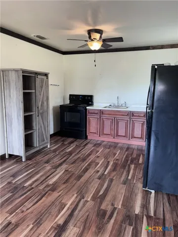 a view of a room with wooden floor