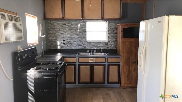 a bathroom with a toilet and a shower curtain