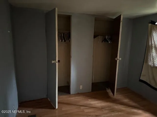 an empty room with wooden floor