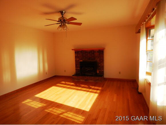 2246 Shutterlee Mill Road Staunton, VA 24401 - Photo 4 of 11 a view of a livingroom with a fireplace and a ceiling fan