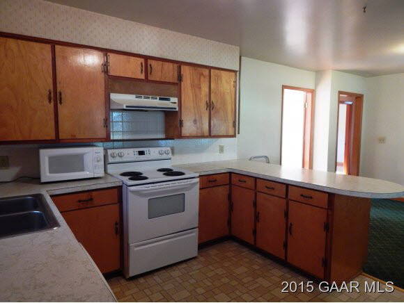 2246 Shutterlee Mill Road Staunton, VA 24401 - Photo 5 of 11 a kitchen with stainless steel appliances granite countertop a stove a sink and a microwave