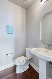 a white toilet sitting next to a bathroom sink