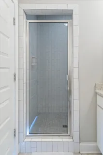 a bathroom with a glass shower door