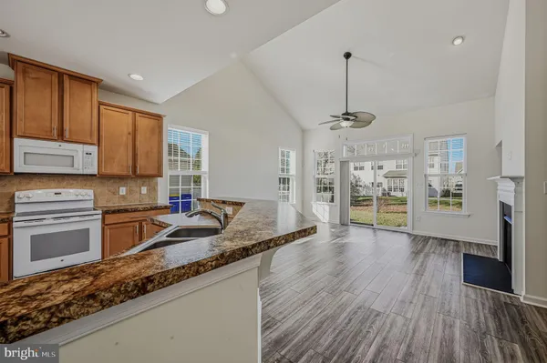 a kitchen with granite countertop wooden floors and granite counter tops