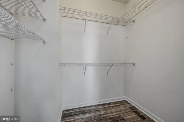 a spacious bathroom with a tub sink and mirror