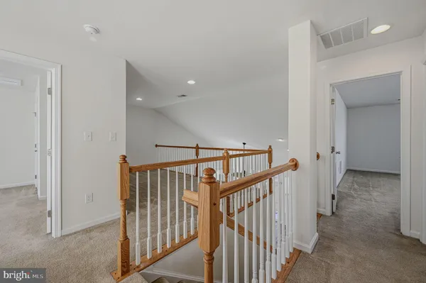 a view of staircase with wooden floor