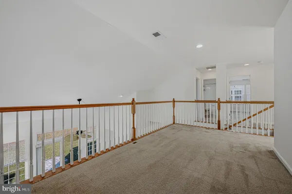 a view of staircase with railing and a projector