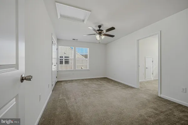 an empty room with windows and entrance