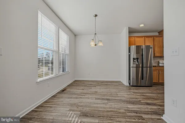 a view of a livingroom with wooden floor and a ceiling fan