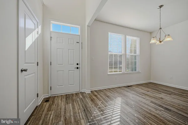 a view of a room with wooden floor and window